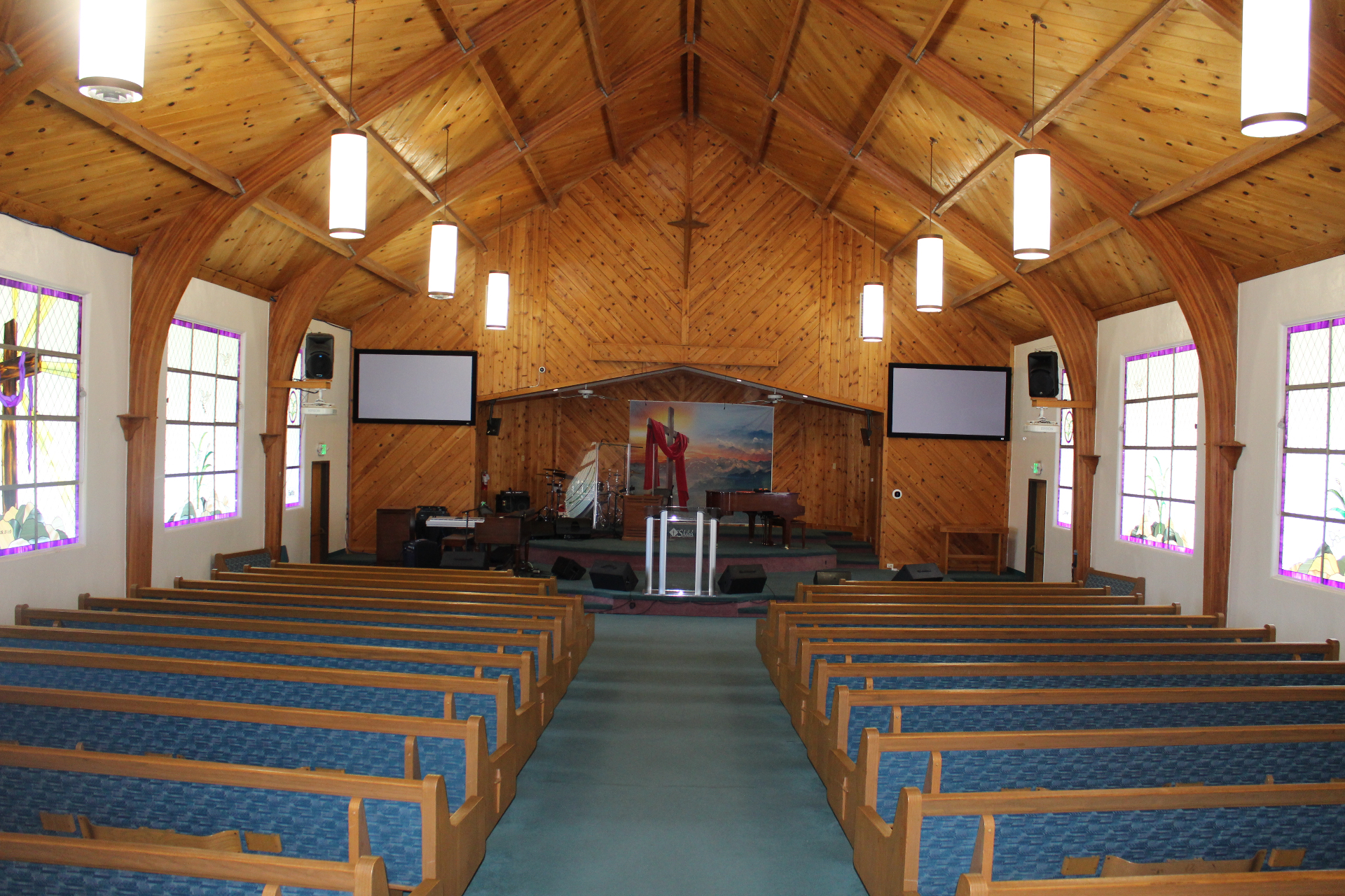 Sanctuary at golden hour with light through stained glass